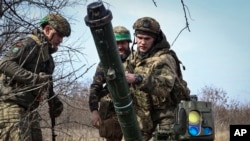 Ukrainian soldiers install an anti-tank missile system near Bakhmut, Donetsk region, Ukraine, March 17, 2023. 