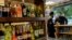People buy alcohol in a liquor store in Baghdad, Iraq, March 9, 2023. The Iraqi government started enforcing a 2016 ban on alcoholic beverages this month, although many liquor shops remained open in Baghdad.