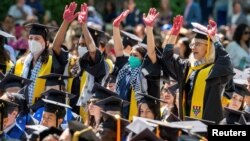 Graduates protest the conflict between Israel and the Palestinian Islamist group Hamas, during the commencement at Yale University in New Haven, Connecticut.