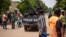 FILE - Police officers drive on a vehicle during a protest called to draw attention to the jihadist threat, in Ouagadougou, Burkina Faso, July 3, 2021. 