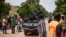 FILE - Police officers drive on a vehicle during a protest called to draw attention to the jihadist threat, in Ouagadougou, Burkina Faso, July 3, 2021. 