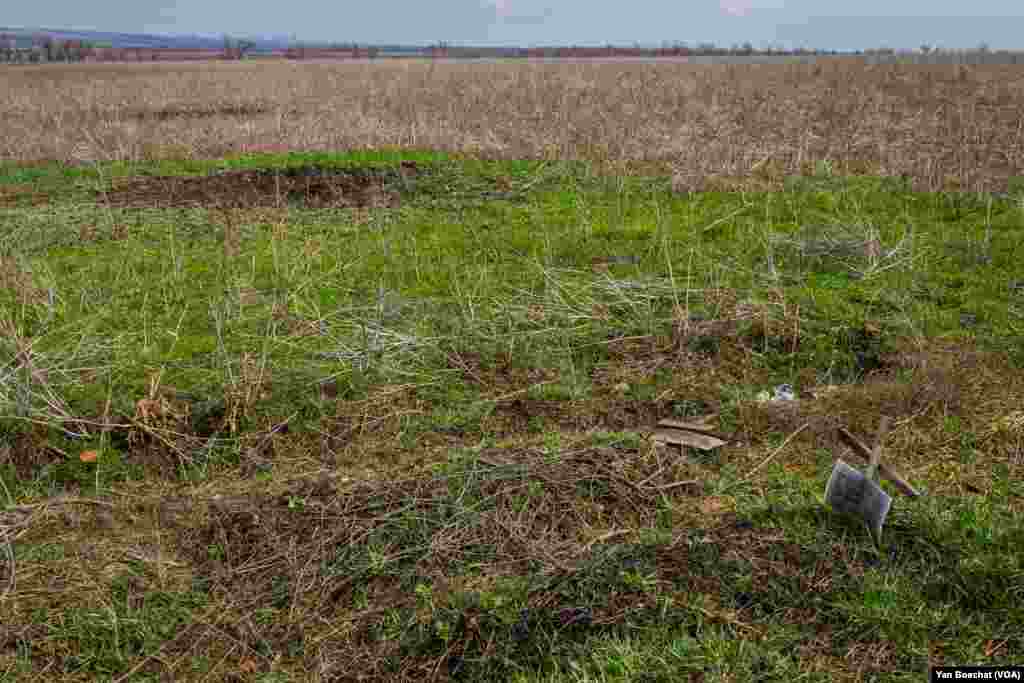Two graves lay on an open field just on the edge of the town of Siversk, a few kilometers away from Russian positions, April 4, 2023.