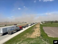 A crash involving at least 20 vehicles shut down a highway in Illinois, Monday, May 1, 2023.