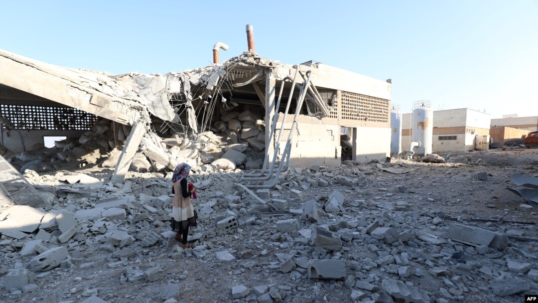 A girl stands amidst debris after Russian airstrikes hit an abandoned water pumping station in Syria's rebel-held northwest, on August 23, 2023. 