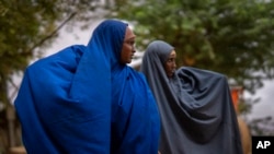 FILE - Two women walk near the Ethiopian border crossing on the outskirts of Dollow, Somalia, Sept. 20, 2022. 
