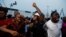 People cheer after poll workers announced results at their polling unit in Awka, Anambra state, Nigeria, Feb. 25, 2023. By evening, some polling stations were already counting ballots while voting was still going on at others and had not taken place elsewhere. 