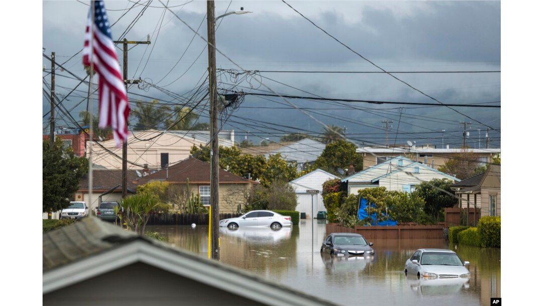 Cars sit partially submerged in floodwaters in Watsonville, California, March 11, 2023.