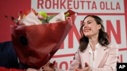 Finnish Prime Minister Sanna Marin, Social Democratic Party is presented flowers during an election party in Helsinki, Finland, April 2, 2023. 