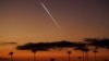 FILE - A SpaceX Falcon 9 rocket carrying 22 Starlink satellites to low-Earth orbit from Space Launch Complex 4 East at Vandenberg Space Force Base streaks over the Pacific Ocean near Encinitas, California, April 1, 2024. 