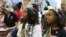 Miss Juneteenth Arizona Shaundrea Norman, 17, left, and Teen Miss Juneteenth Arizona Kendall McCollun, 15, attend an annual Juneteenth celebration at Eastlake Park in Phoenix,  June 18, 2022. 