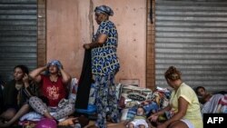 FILE - Residents take shelter outside shops in the old quarters of Marrakesh on September 12, 2023, after their houses were deemed unsafe due to the 6.8-magnitude earthquake. 