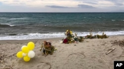 Flowers are left where the wreckage of a capsized boat washed ashore at a beach near Cutro, southern Italy, March 9, 2023. More than 70 people died in a recent shipwreck on Italy's Calabrian coast. 
