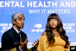 FILE - U.S. Surgeon General Vivek Murthy, left, speaks during a forum on mental health with Naomi Osaka during the U.S. Open tennis championships on Sept. 6, 2023, in New York. (AP Photo/Mary Altaffer)