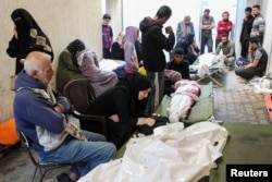 Mourners react next to the bodies of Palestinians killed in Israeli strikes during their funeral in Rafah in the southern Gaza Strip, May 16, 2024.