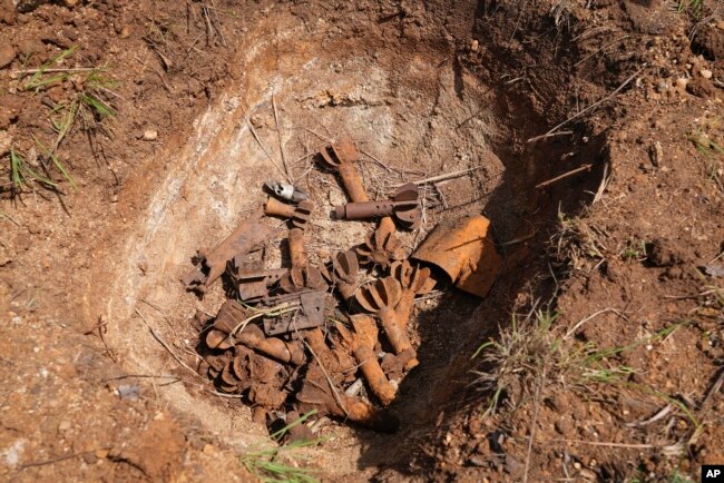 Remnants of cluster munitions are seen at a clearance site in Ayii, Eastern Equatoria state, in South Sudan Thursday, May 11, 2023. (AP Photo/Sam Mednick)