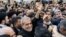 Iran's newly-elected President Masoud Pezeshkian, center, waves to supporters as he visits the shrine of the Islamic Republic's founder Ayatollah Ruhollah Khomeini in Tehran, Iran, July 6, 2024. 