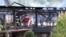 Firefighters inspect a burned building after a fire erupted at a holiday home for people with disabilities in Wintzenheim, France, Aug. 9, 2023. Eleven people died in the fire.