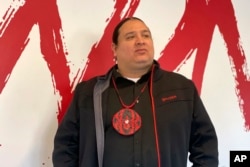 FILE - NDN Collective founder and CEO Nick Tilsen stands in the organization's headquarters in Rapid City, South Dakota, Feb. 10, 2023. Tilsen traces the roots of his activism to Wounded Knee.