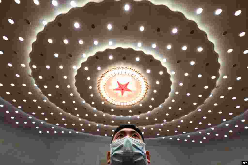 A security officer stands guard after the second plenary session of the National People's Congress (NPC) at the Great Hall of the People in Beijing.