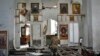 A Ukrainian serviceman prays kneeling in a church damaged in the Russian air raid in the town of Orikhiv, Zaporizhzhia region, Ukraine, April 5, 2024. 