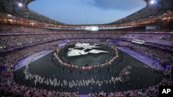 Flag bearers march during the 2024 Summer Olympics closing ceremony at the Stade de France, Aug. 11, 2024, in Saint-Denis, France. 