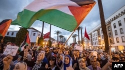 Moroccans wave the Palestinian flag during a gathering in Rabat in support of Palestinians in the Gaza Strip, Oct. 20, 2023. 