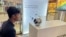 FILE - An engineer in Bengaluru, India, signs up for Worldcoin by having his eyes scanned by the spherical device at a local mall on July 25, 2023. A panel in Kenya has urged the shutdown of the crypto project there pending more stringent regulations. 