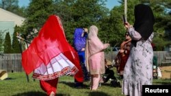 FILE - Afghan refugees dress in traditional clothes while celebrating the Muslim festival in Louisville, Kentucky, U.S., May 2, 2022. (REUTERS/Amira Karaoud/File Photo)