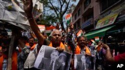 Activists of right-wing Hindu groups reacting to Monday’s killing of five Indian soldiers in Indian-controlled Kashmir’s Kathua district, hold photographs of Pakistan Prime Minister Shehbaz Sharif in Jammu, India, July 9, 2024.