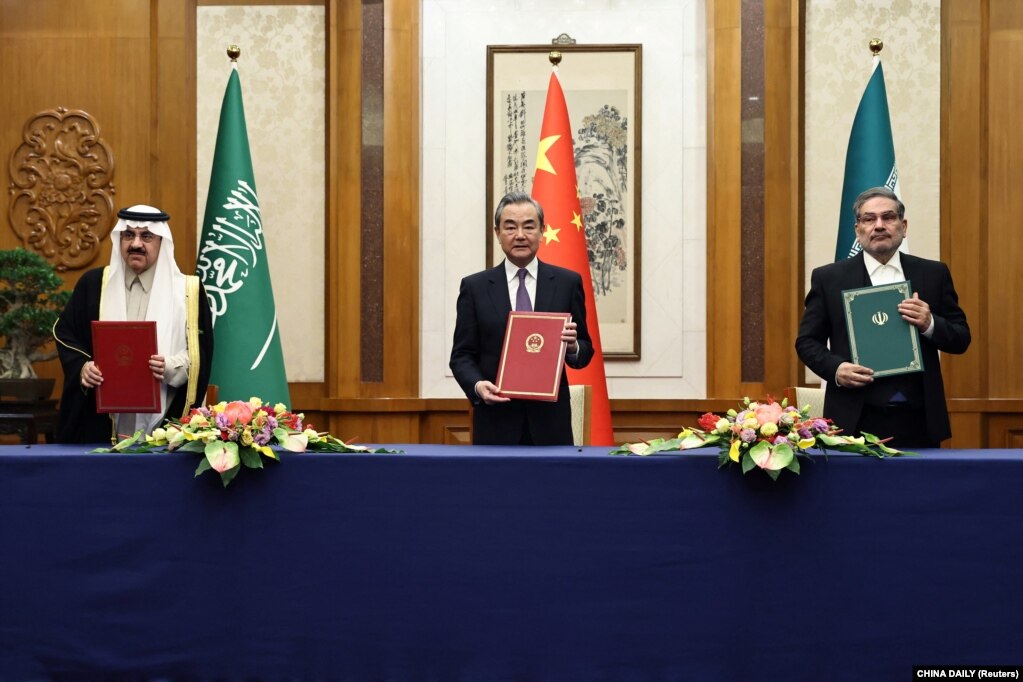 中共中央外办主任王毅与伊朗最高国家安全委员会秘书阿里·沙姆哈尼（右）同沙特国务大臣、内阁成员和国家安全顾问穆萨伊德·本·穆罕默德·艾班在北京举行会谈。（2023年3月10日）(photo:VOA)