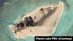 Satellite imagery of Triton Island taken by Planet Labs PBC in August 2023 shows what appears to be a runway or a roadway jutting toward the east. 
