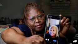 Janet Jarrett shows a photo of her sister, Pamela Jarrett, she keeps on her phone at the home they shared in Spring, Texas, July 19, 2024. Pamela Jarrett passed away after suffering heat related distress due to the power outage caused by hurricane Beryl.