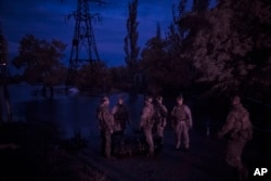 Ukraine Special Operations Forces soldiers prepare for a night mission on the Dnipro River near Kherson, Ukraine, on June 11, 2023.