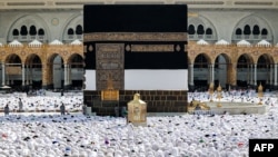 Muslim worshipers pray around the Kaaba, Islam's holiest shrine, at the Grand Mosque in Saudi Arabia's holy city of Mecca, June 4, 2024 as pilgrims arrive ahead of the annual hajj pilgrimage.