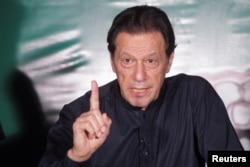 Pakistan's former Prime Minister Imran Khan, gestures as he speaks to the members of the media at his residence in Lahore, May 18, 2023.