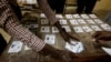 FILE - Election workers count ballot papers following a presidential election at a polling station in Dakar, Senegal, March 24, 2024.