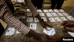 FILE - Election workers count ballot papers following a presidential election at a polling station in Dakar, Senegal, March 24, 2024.