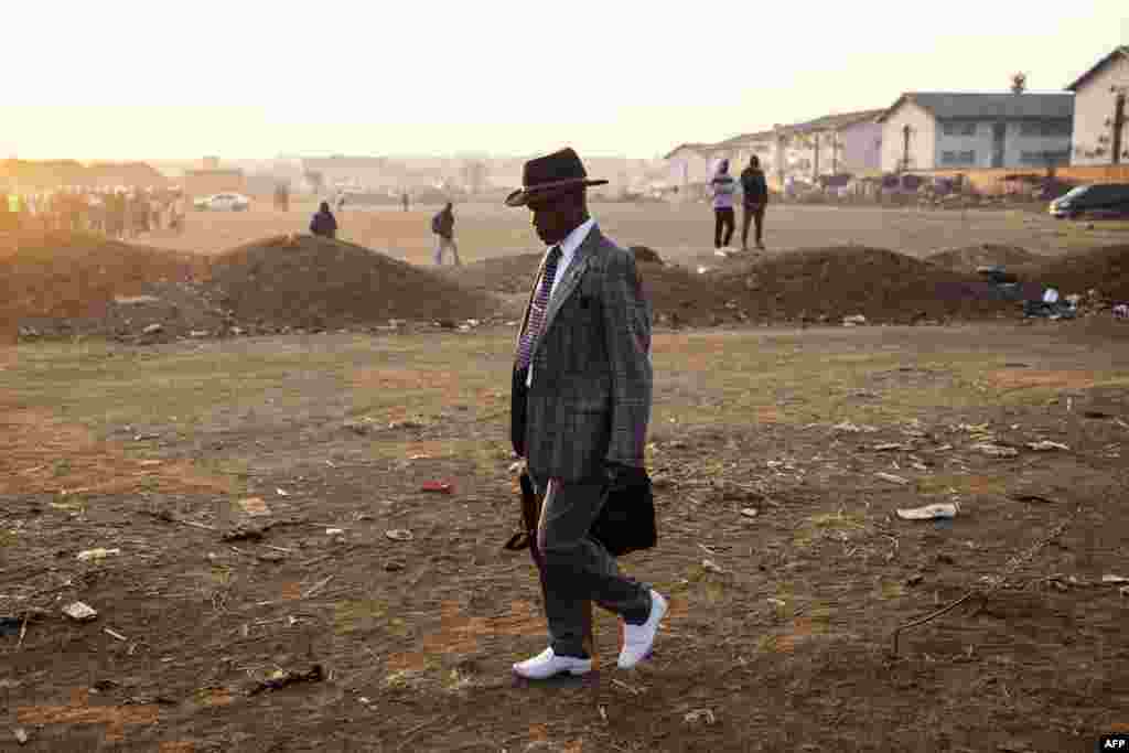 A man walks to a polling station during the presidential and legislative elections in Mbare, Harare.