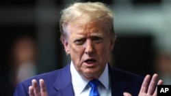 Former President Donald Trump speaks to media as he returns to his trial at the Manhattan Criminal Court, Friday, May 3, 2024, in New York. (Charly Triballeau/Pool Photo via AP)