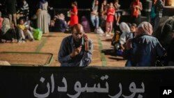 A Sudanese evacuee waits at Port Sudan before boarding a Saudi military ship to Jeddah port, on May 3, 2023.