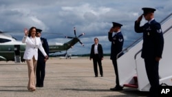 Democratic presidential nominee Vice President Kamala Harris, left, walks to board Air Force Two, Aug. 7, 2024, at Joint Base Andrews, Maryland, en route to Eau Claire, Wisconsin. 