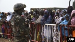 FILE: A Niger Army soldier stands guard, as supporters wait for the arrival of Niger President Mohamed Bazoum, in Sara-Koira on September 11, 2021. - In recent months, attacks, often by perpetrators on motorcycles, have intensified against civilians in this heavily forested area.