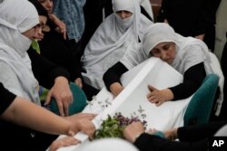 Members of the Druze minority mourn during the funeral of their relatives at the village of Majdal Shams in the Israeli-controlled Golan Heights, July 28, 2024.