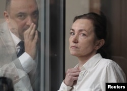 Russian-American journalist for Radio Free Europe/Radio Liberty Alsu Kurmasheva, who is in custody after she was accused of violating Russia's law on foreign agents, listens to her lawyer Edgar Matevosyan during a court hearing in Kazan, Russia, April 1, 2024.