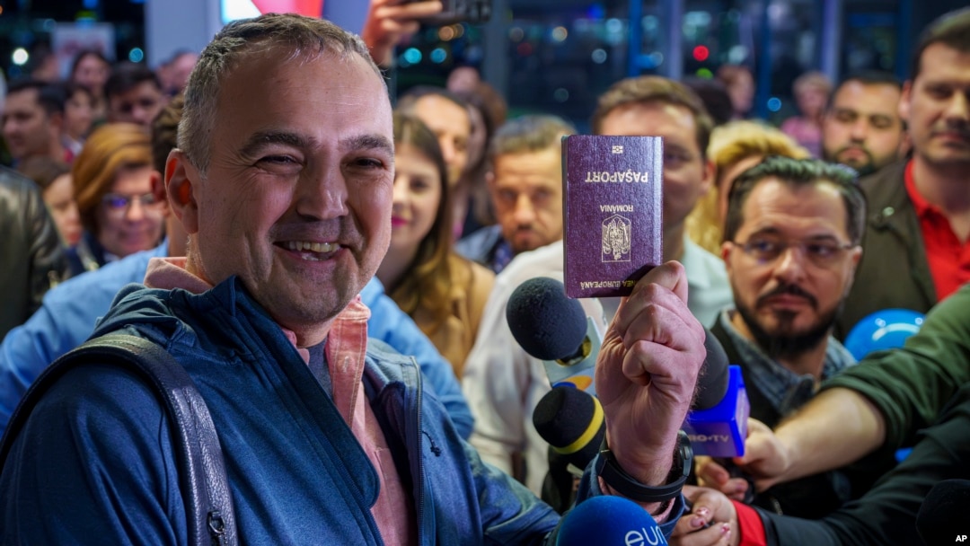 A passenger who arrived on a flight from Vienna shows his passport after being one of the first people to take advantage of Romania's entry in the Schengen Area, at Henri Coanda International Airport, near Bucharest, March 31, 2024.
