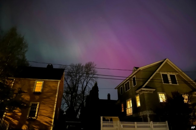 Northern lights shine over Portsmouth, N.H., Friday, May 10, 2024. (AP Photo/Caleb Jones)