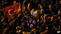 Supporters of Republican People's Party use their cellphones to watch the election results outside the headquarters of CHP, in Ankara, Turkey, May 14, 2023. 