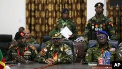 Ghana's Vice Admiral Seth Amoama, center, flanked by Lieutenant General Yankuba Drammeh of Gambia, left, and Ivory Coast General Lassina Doumbia, listen during a meeting of ECOWAS defense chiefs in Accra, Ghana, Aug. 18, 2023.