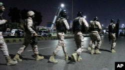 Paramilitary soldiers arrive at the incident site following an attack by gunmen on police headquarters in Karachi, Pakistan, Feb. 17, 2023. Militants launched a brazen attack on the police headquarters of Pakistan's largest city on Friday, officials said. 