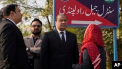 Salman Sardar, center, a lawyer of Pakistan's former Prime Minister Imran Khan's legal team, talks with colleagues as he arrives for a hearing at a special court in Adiyala prison, in Rawalpindi, Pakistan, Dec. 12, 2023.